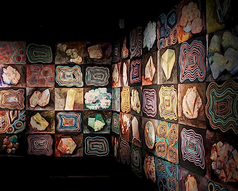 An image of various indigenous art pieces feature in a gallery