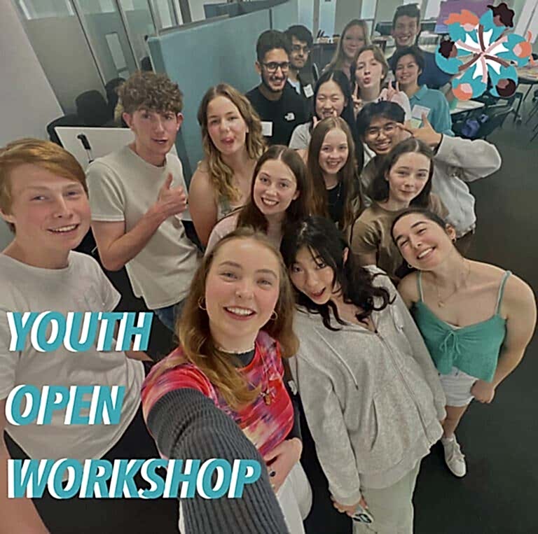 A selfie taken of a group of young people with the words "youth open workshop" in the bottom left corner