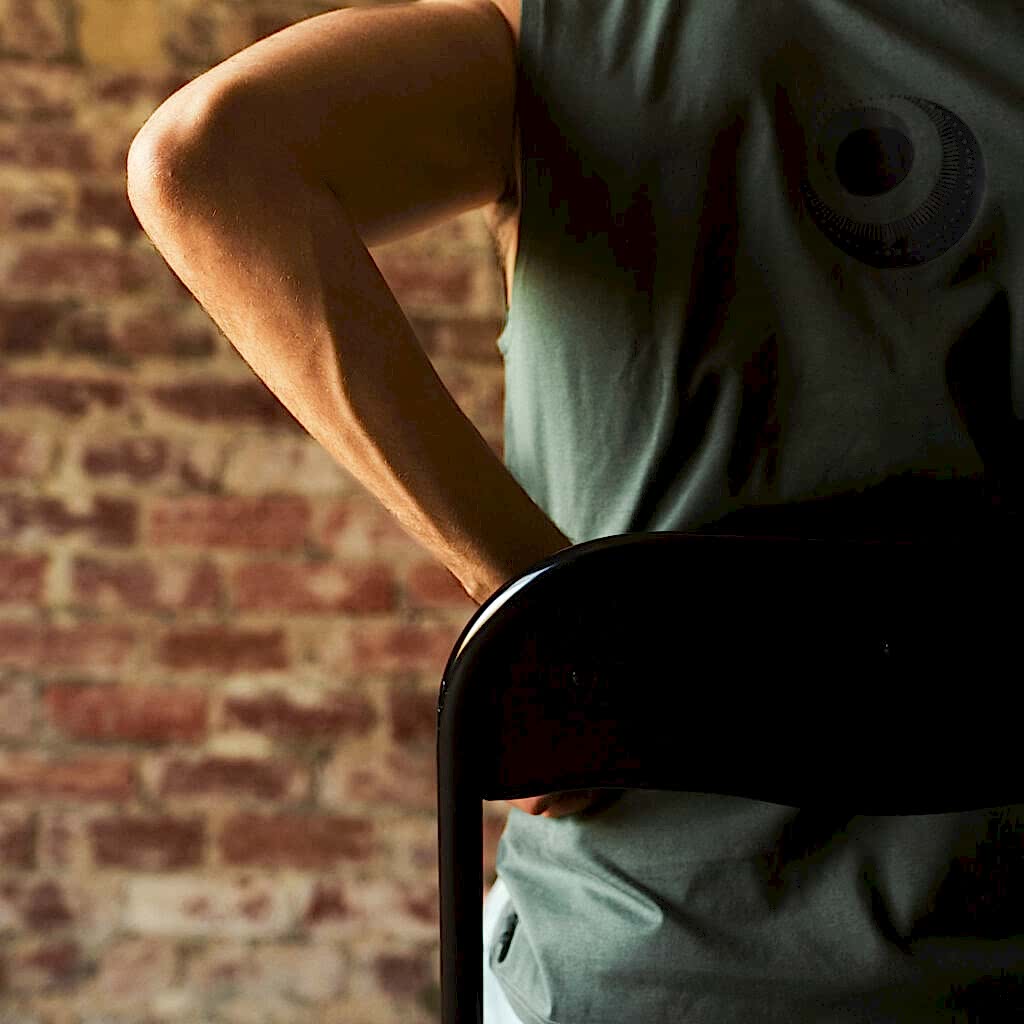 a man sits in a chair with back facing the camera